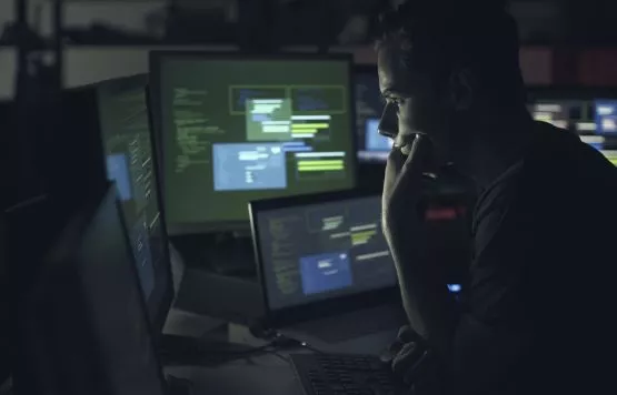 Man working on computer with multiple monitors