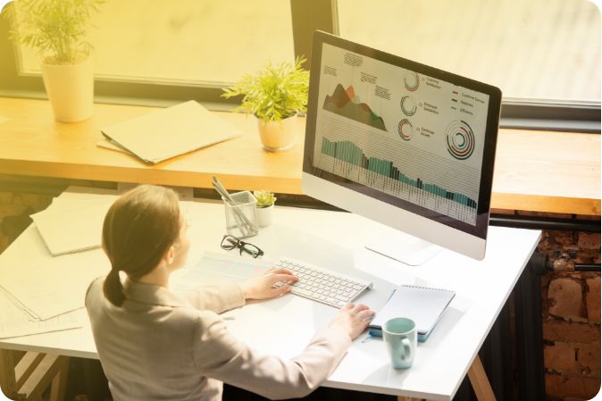 Woman using desktop pc to media monitoring statistics