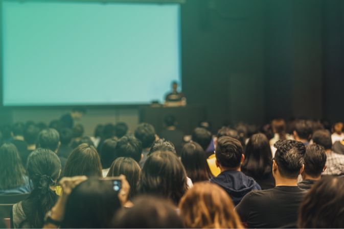 Large young audience listening to educational speech