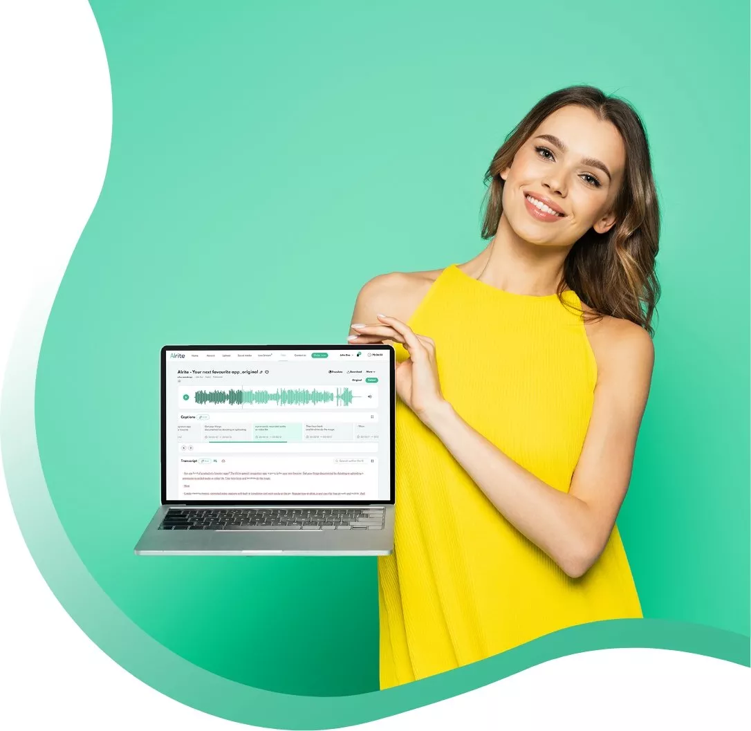 happy woman in yellow dress holding a laptop with the Alrite speech to text app open