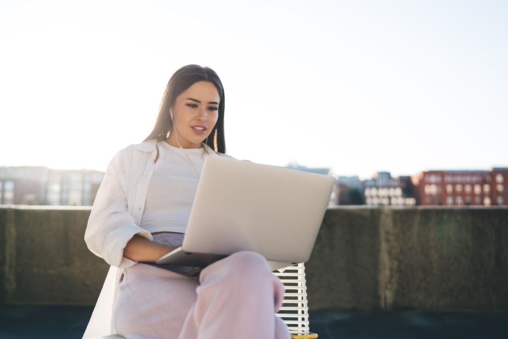 A young woman using AI tools while working from home