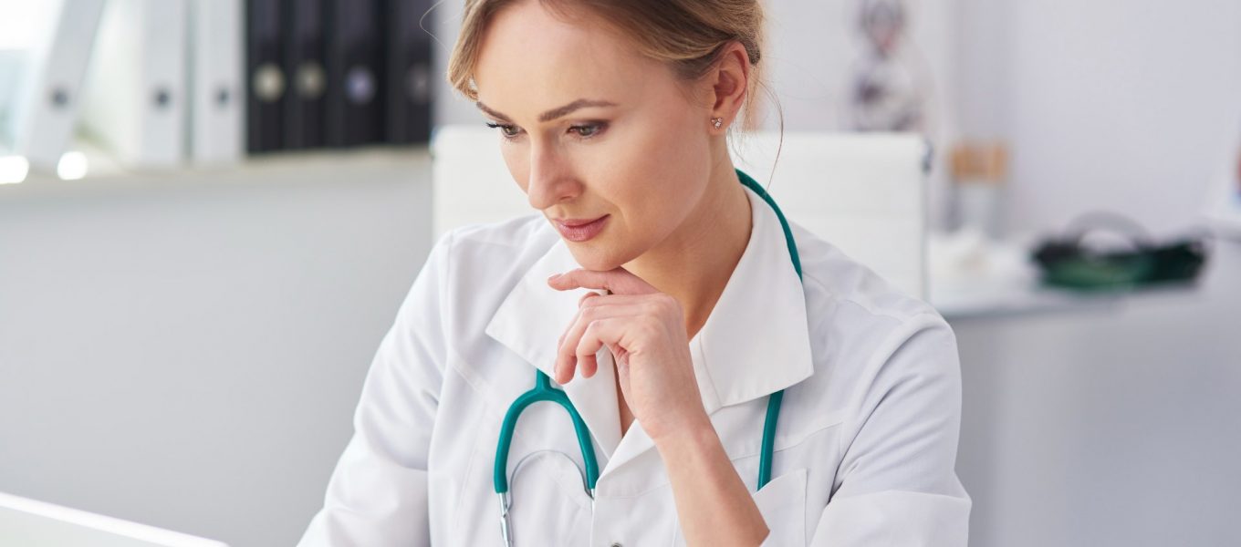 Doctor using her laptop to transcribe what she speaks about with her patients